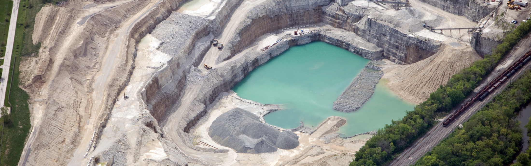 Aerial view of a large quarry and rock crushing operation.