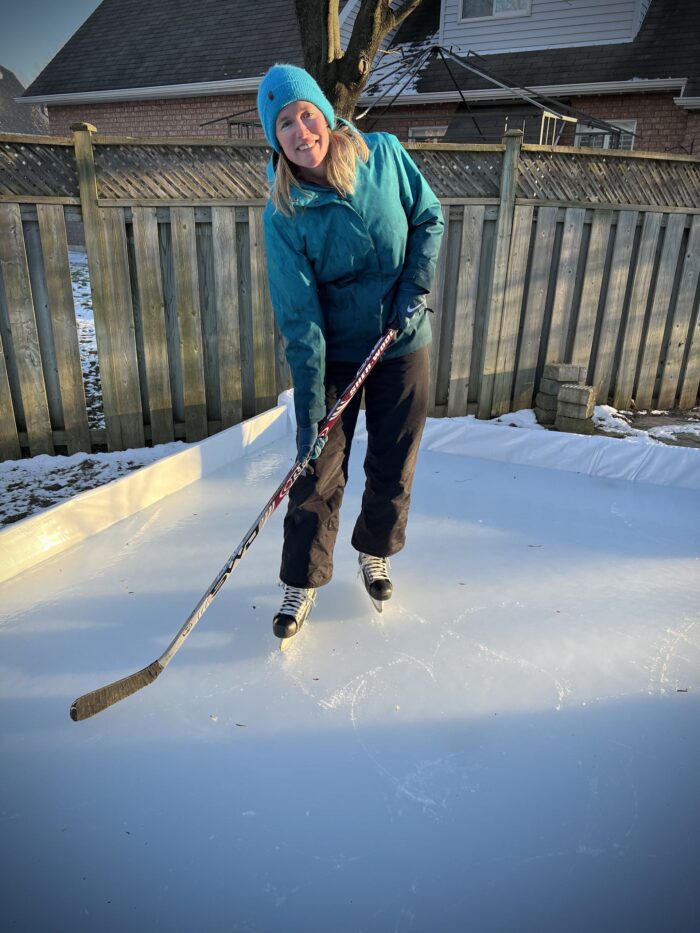 Gillian Dunlop wearing ice hockey gear in the snow.